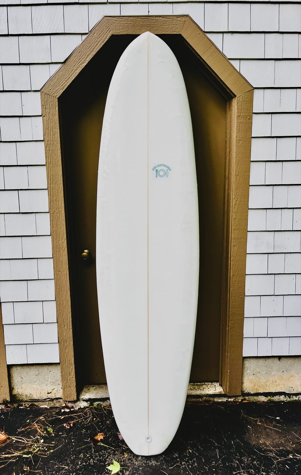 A longboard standing in a doorway